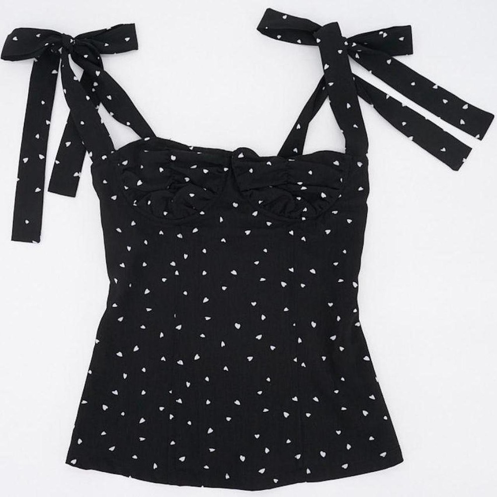 Lioness black corset-style top covered in tiny white hearts